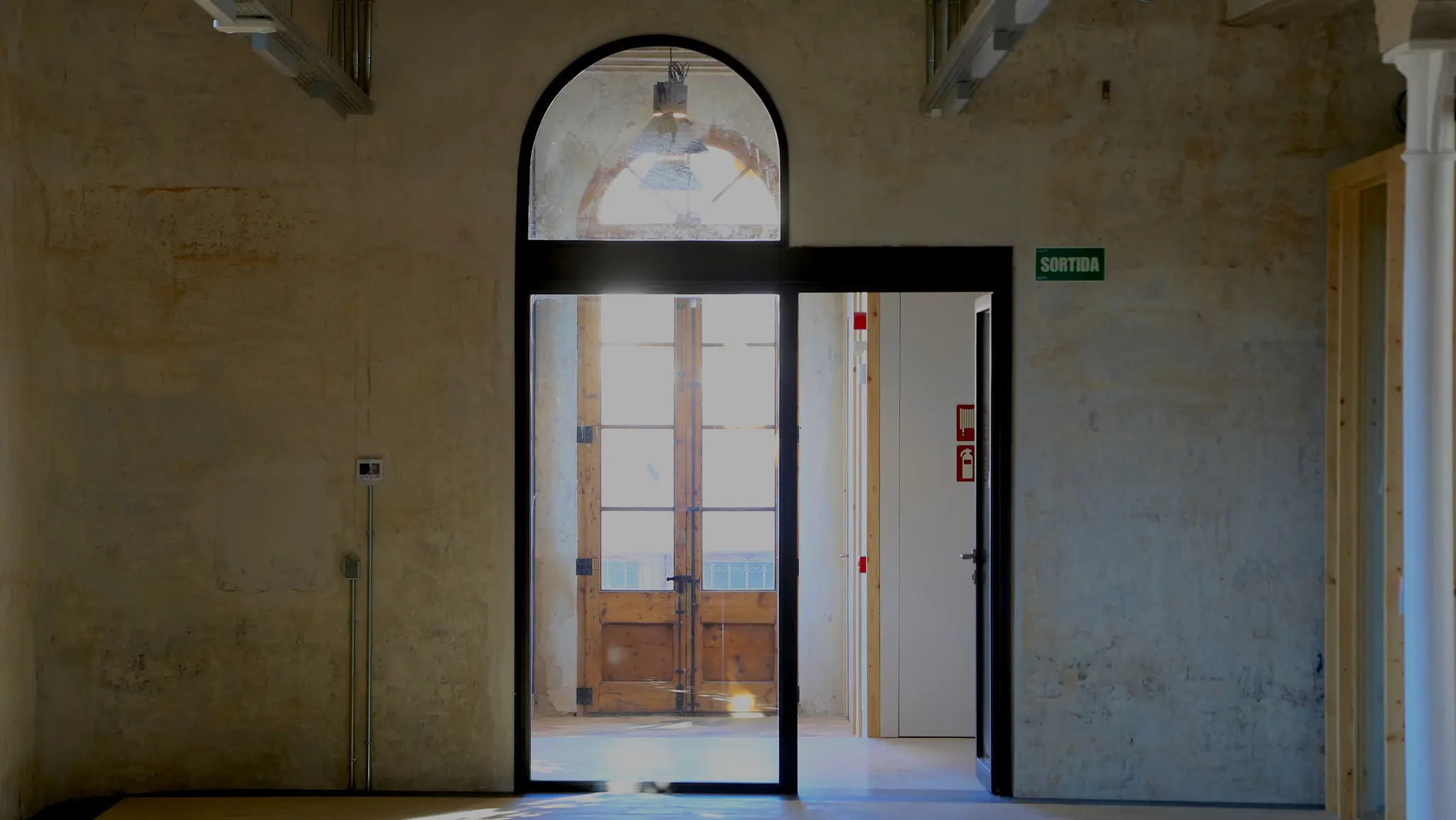 Construction site interior with arched windows